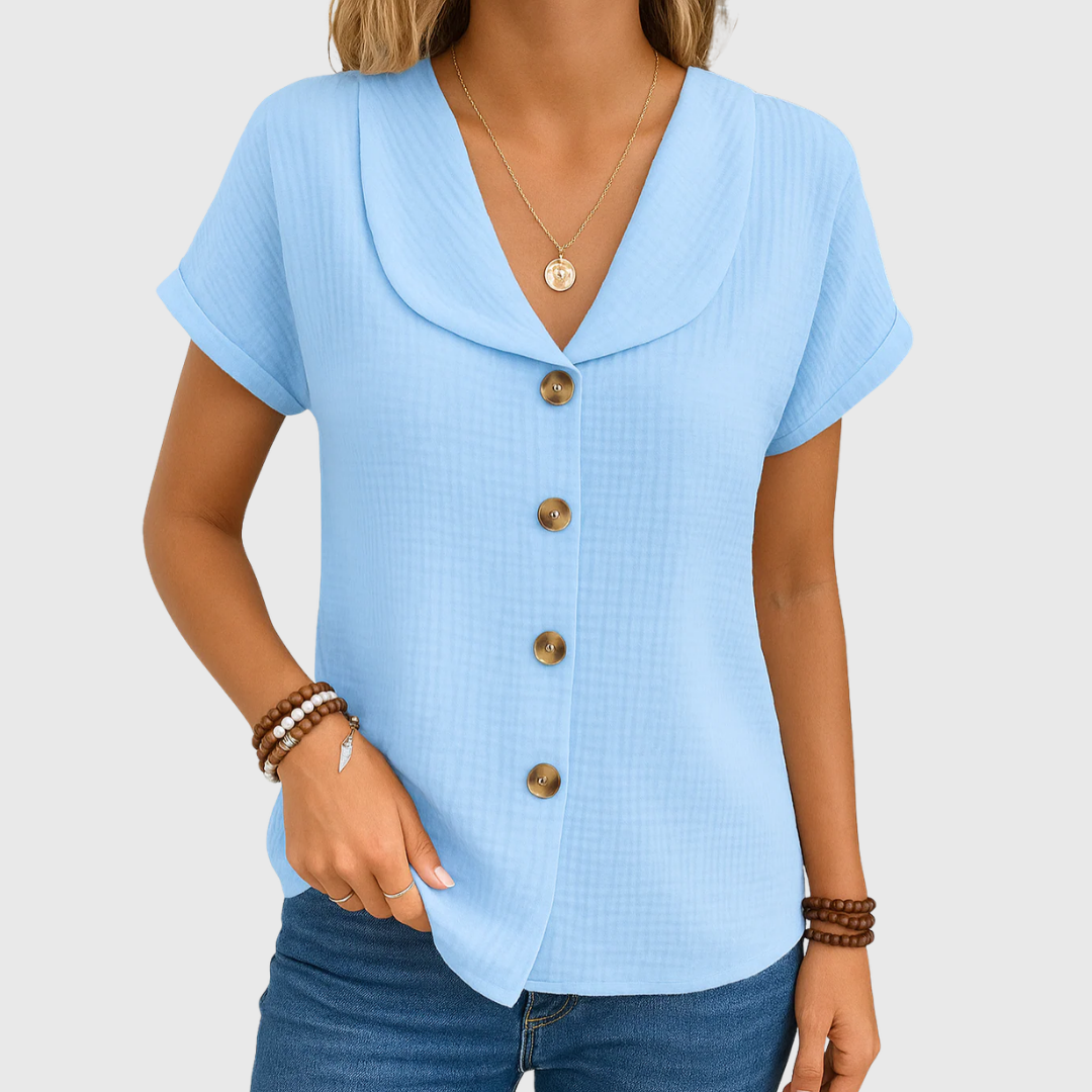 Light blue buttoned blouse with V-neck, short sleeves, and bronze front buttons
