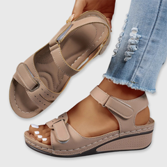 Tan leather open-toe sandals with two hook-and-loop straps and cushioned footbed