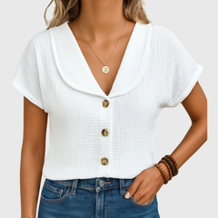 White buttoned blouse with V-neck and short sleeves, front button placket