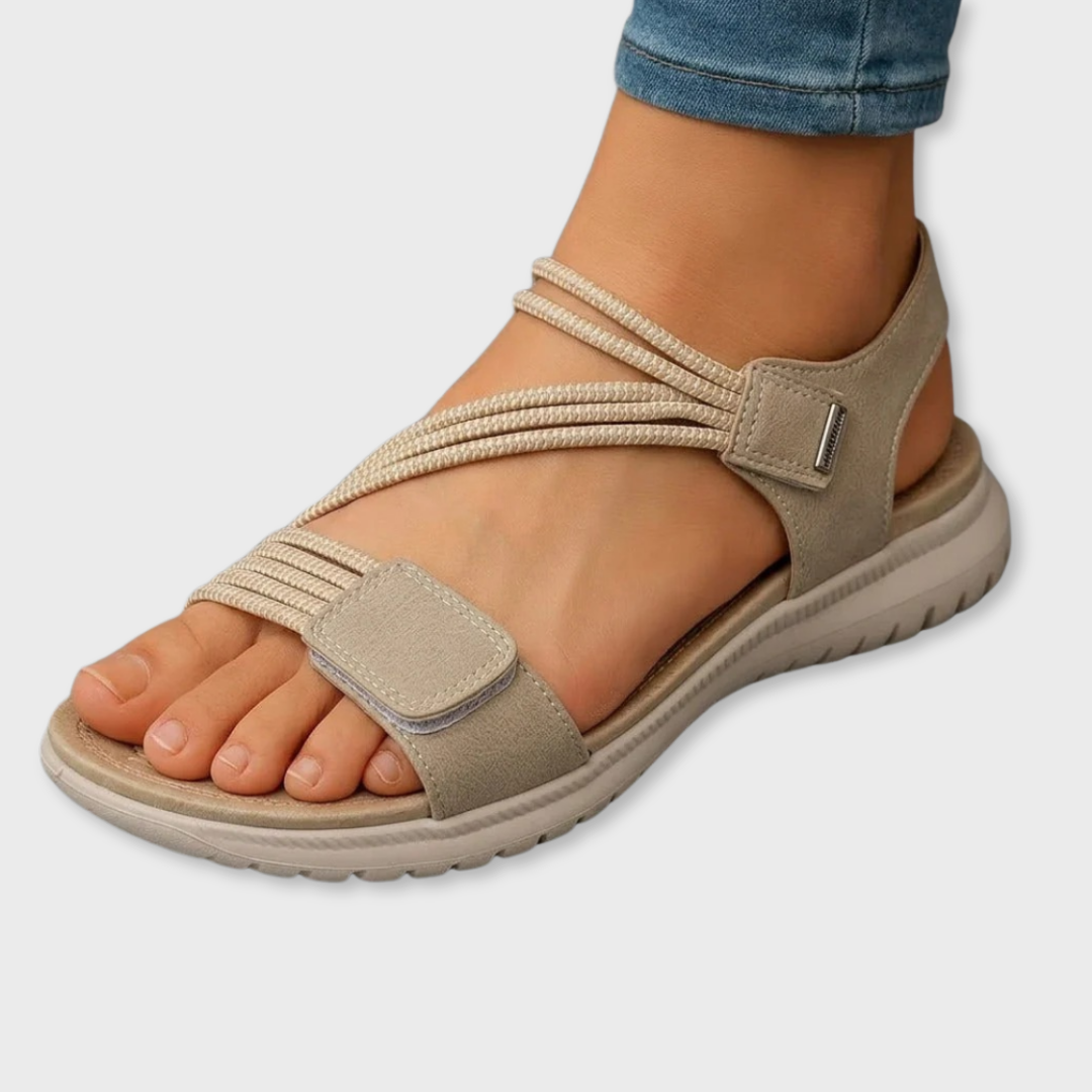 Beige open-toe sandals with two hook-and-loop straps and cushioned sole