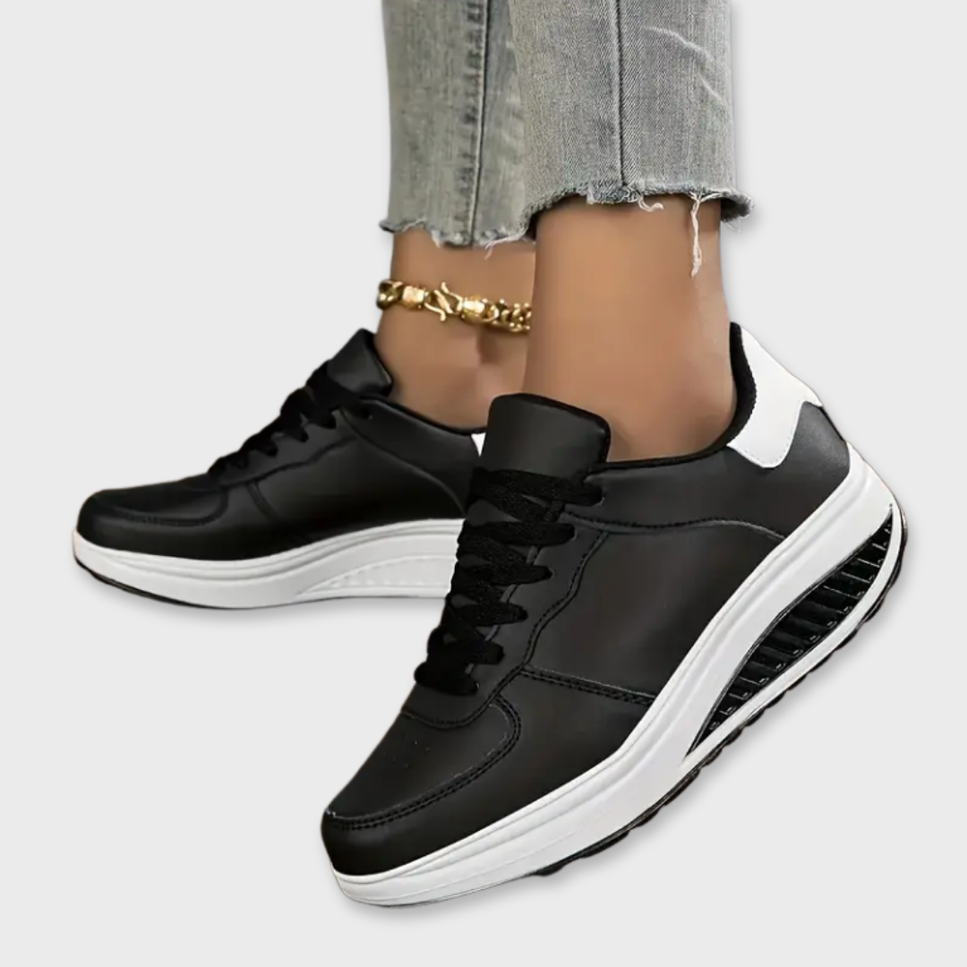 Black platform comfort sneakers with white sole accents and lace-up front