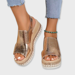 Silver metallic open-toe platform sandals with ankle strap buckle and textured sole