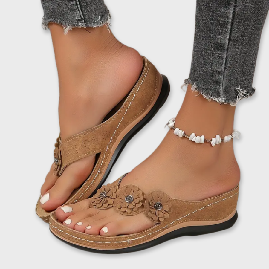 Brown comfort sandals with floral applique and white beaded ankle strap