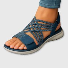 Blue woven strappy sandals with open toe, crisscross upper, and cushioned sole