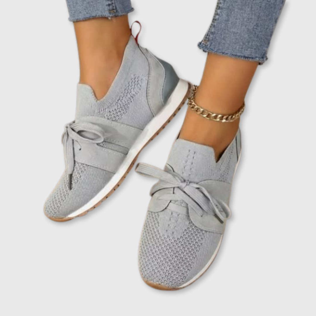 Gray comfort sneakers with knit upper, lace-up ties, and cushioned sole.