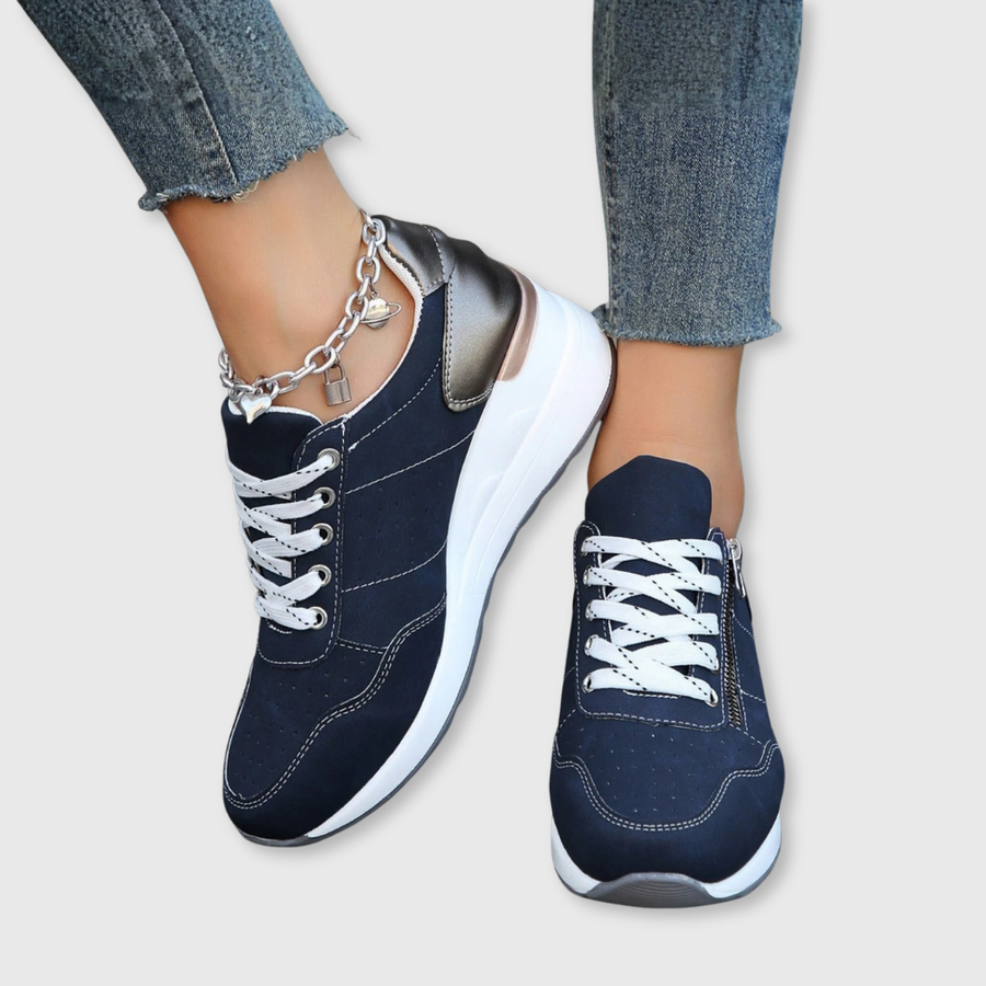 Navy zip-up comfort sneakers with lace-up front, white sole, side zipper, chain charm