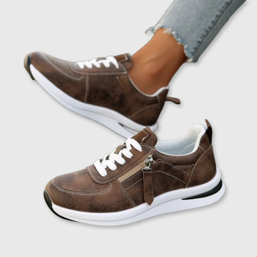 Brown zip-up comfort sneakers with white laces and front zipper, chunky white sole