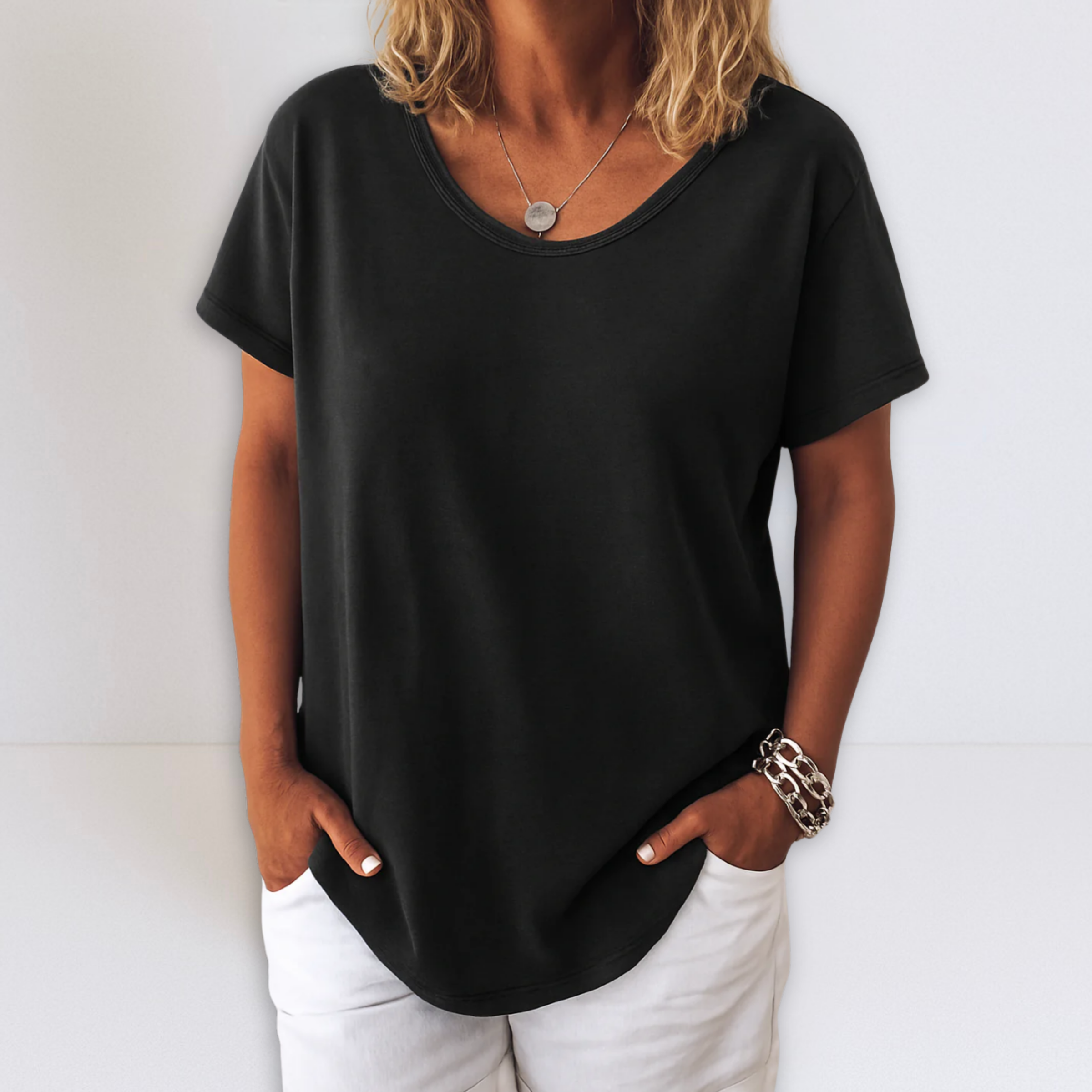Oversized V-neck blouse in black, short sleeves with relaxed fit and draped hem