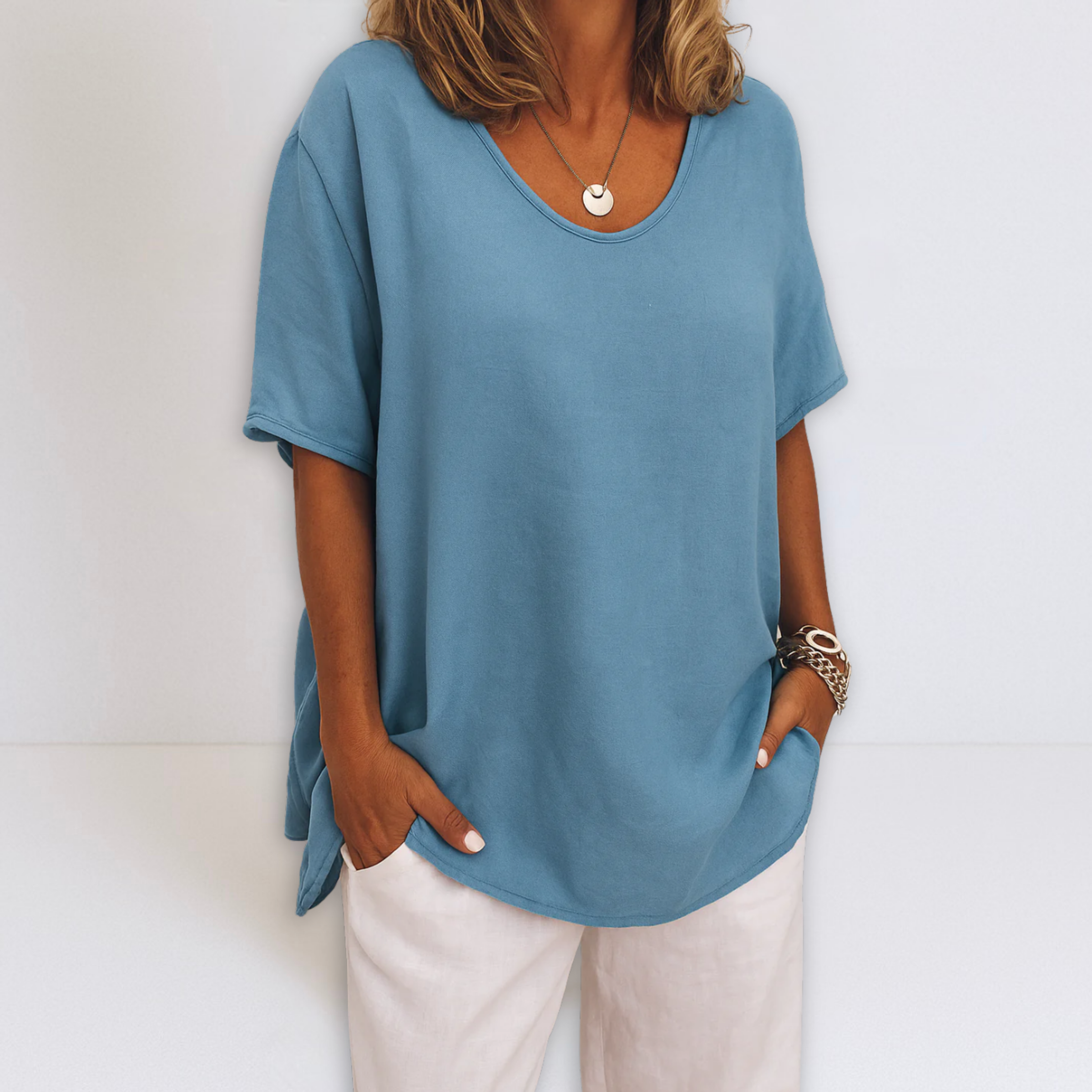 Oversized V-neck blouse in sky blue, short sleeves with loose fit and side drape