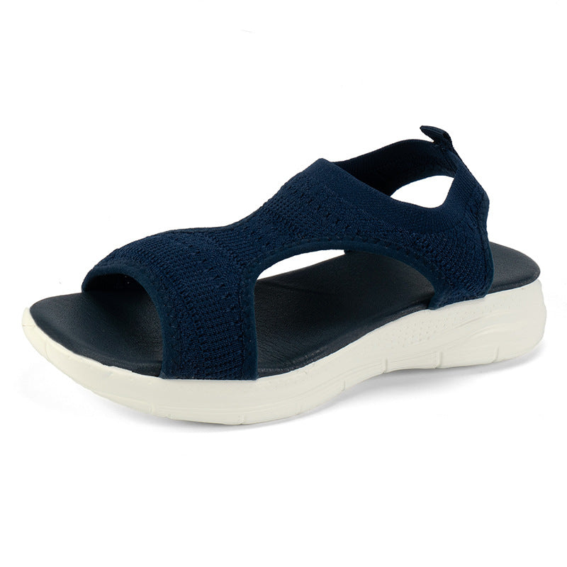 Navy blue knit slip-on sandals with open toe and white cushioned sole