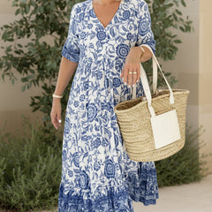Light blue bohemian dress with V-neck, short sleeves, tiered floral print.