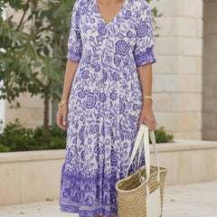 Lavender purple bohemian dress with V-neck, short sleeves, tiered floral print.