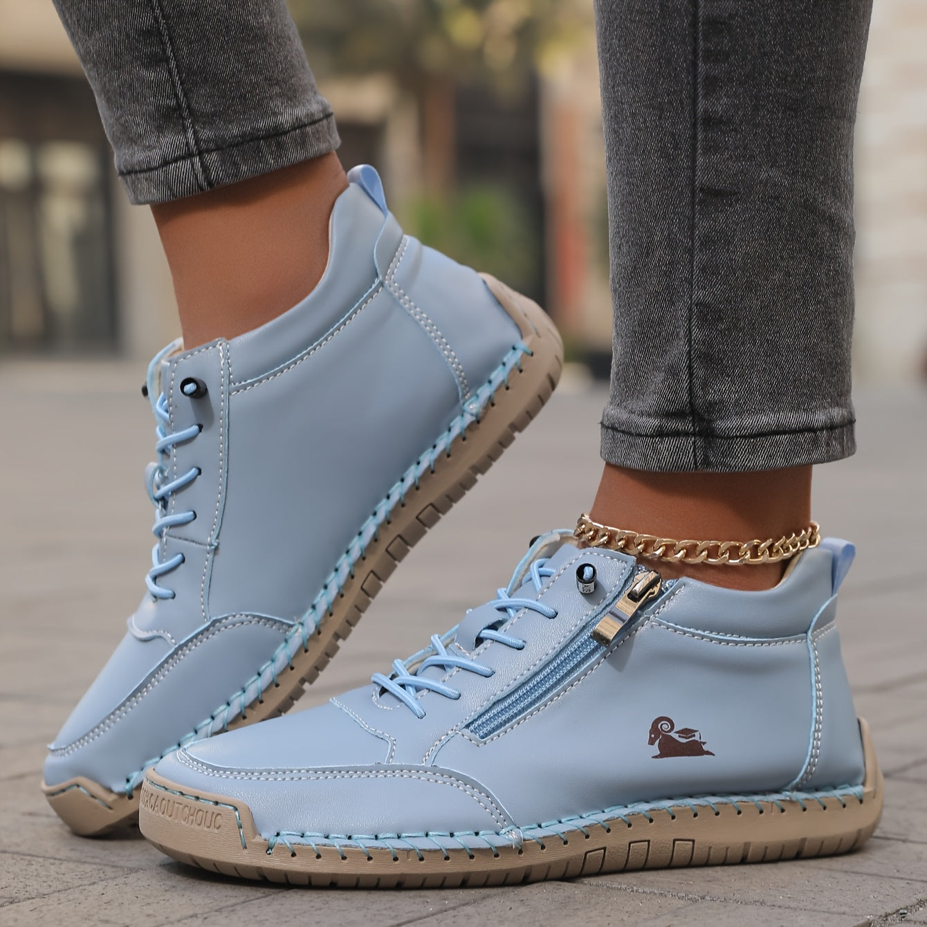 Light blue zip-up comfort shoes with lace-up laces, side zipper tab, and stitched sole