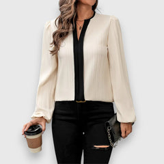 Zoe long-sleeve blouse in cream with black V-neck placket and vertical texture