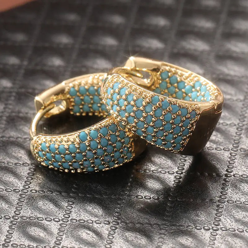 Gold-tone turquoise beaded hoop earrings, close-up side angle