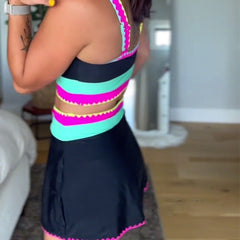 Three-piece swimsuit with black base, hot pink and turquoise striped accents, back view