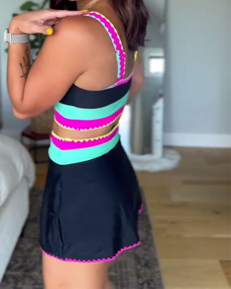 Three-piece swimsuit with black base, hot pink and turquoise striped accents, back view