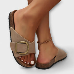 Beige sandals with gold buckle ankle strap and cork sole, open toe