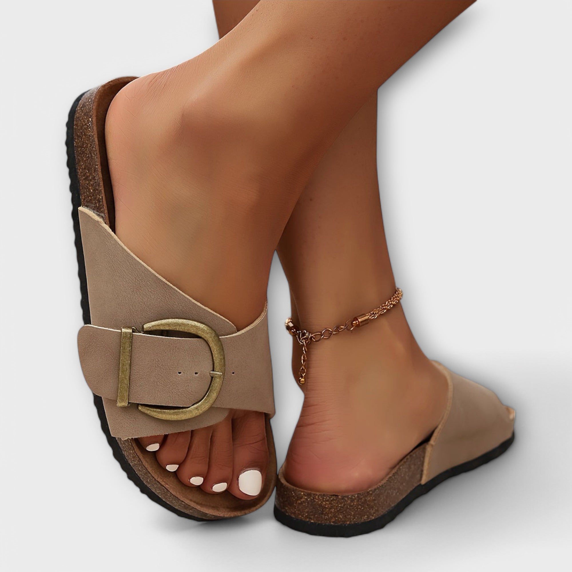 Beige sandals with gold buckle ankle strap and cork sole, open toe