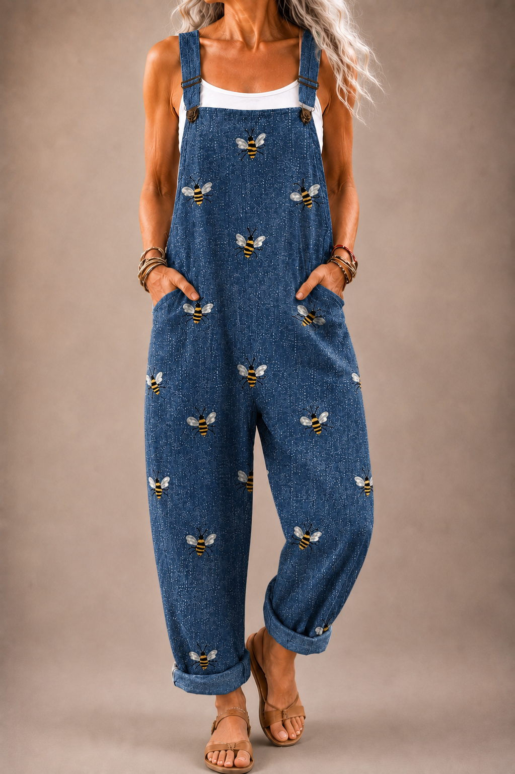 Denim blue bee-print overalls with adjustable blue straps and front pockets