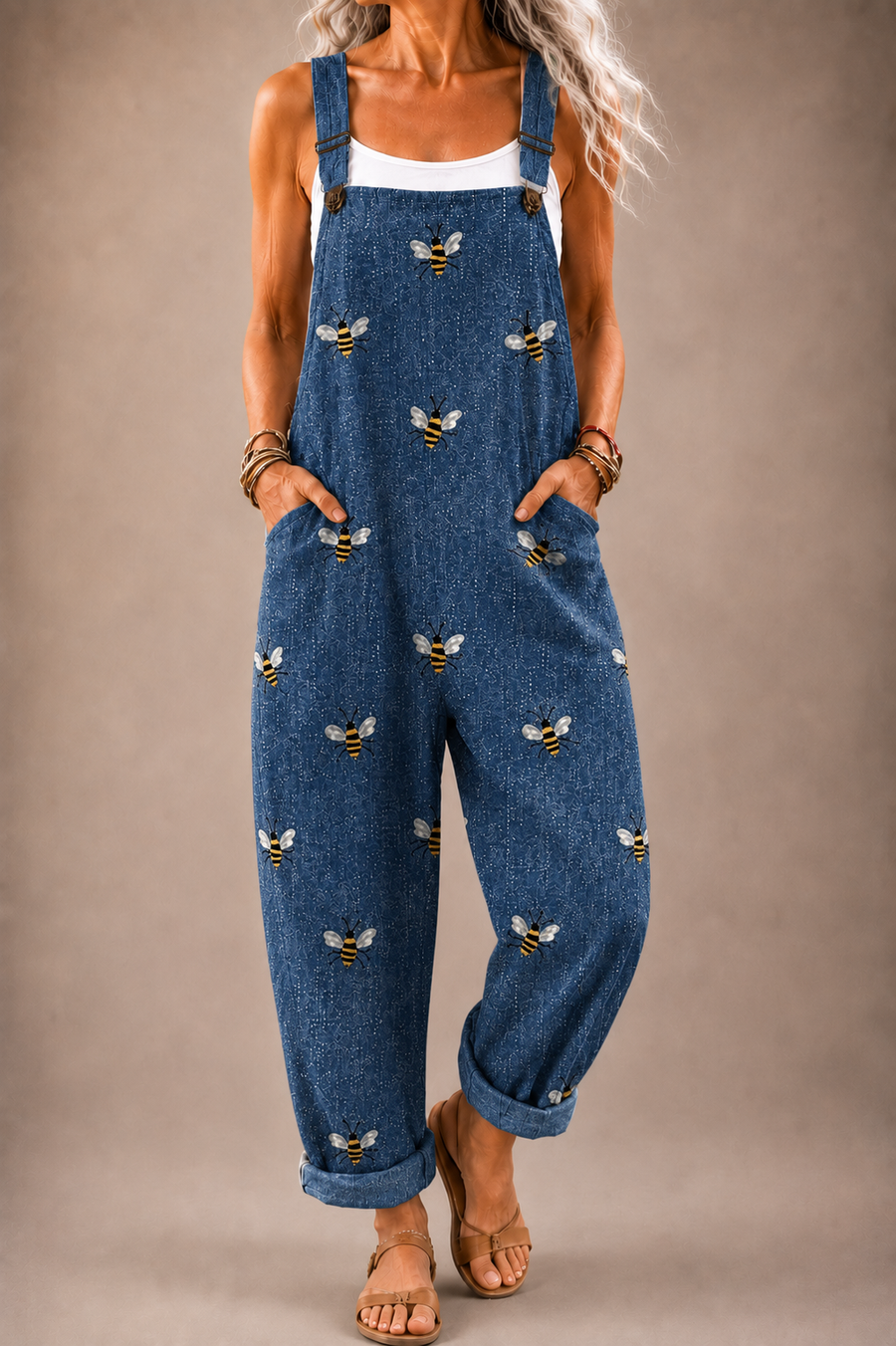 Denim blue bee-print overalls with adjustable blue straps and front pockets