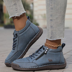 Blue zip-up comfort shoes with lace-up closure, side zipper tab, and stitched trim