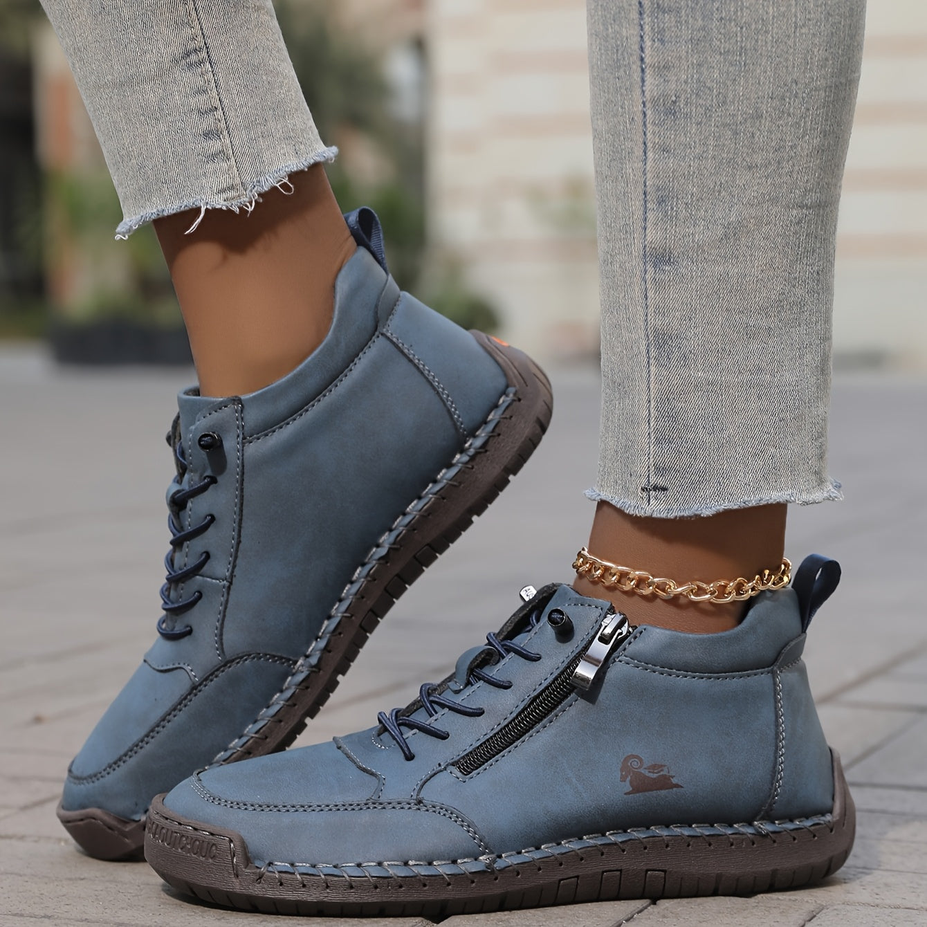 Blue zip-up comfort shoes with lace-up closure, side zipper tab, and stitched trim