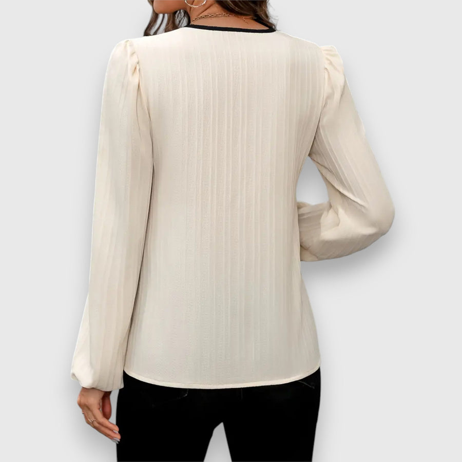 Long-sleeve cream blouse back view with vertical stripes and gathered cuffs