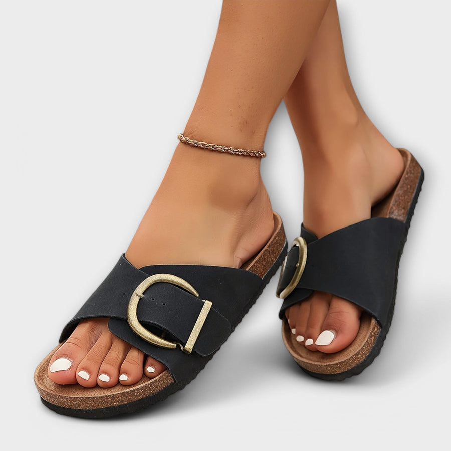 Black soft-glide sandals with gold buckle and open toe, textured cork sole