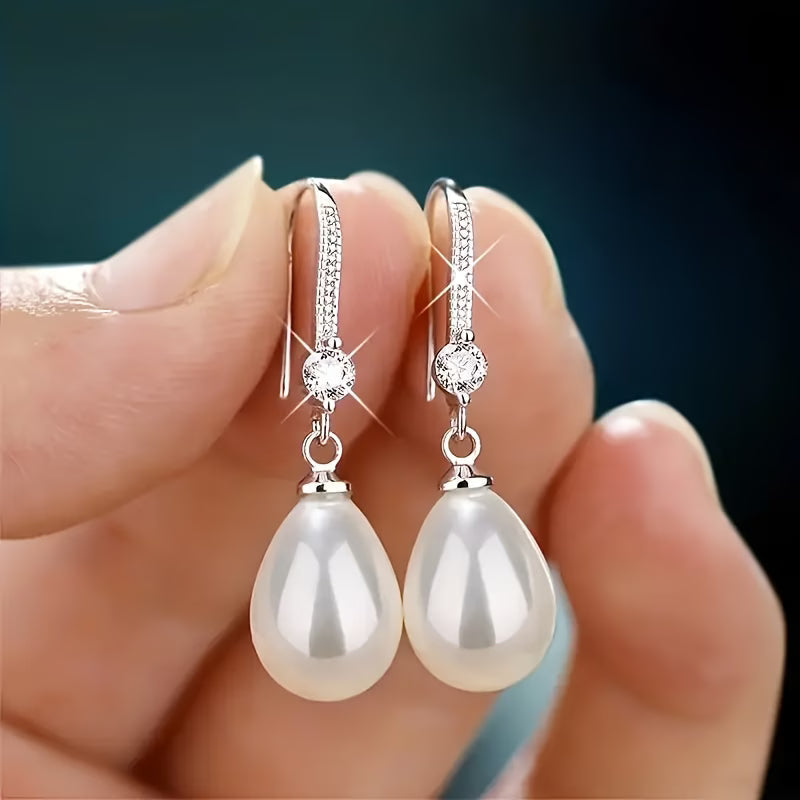 Silver-tone drop earrings with textured round caps and white teardrop pearls