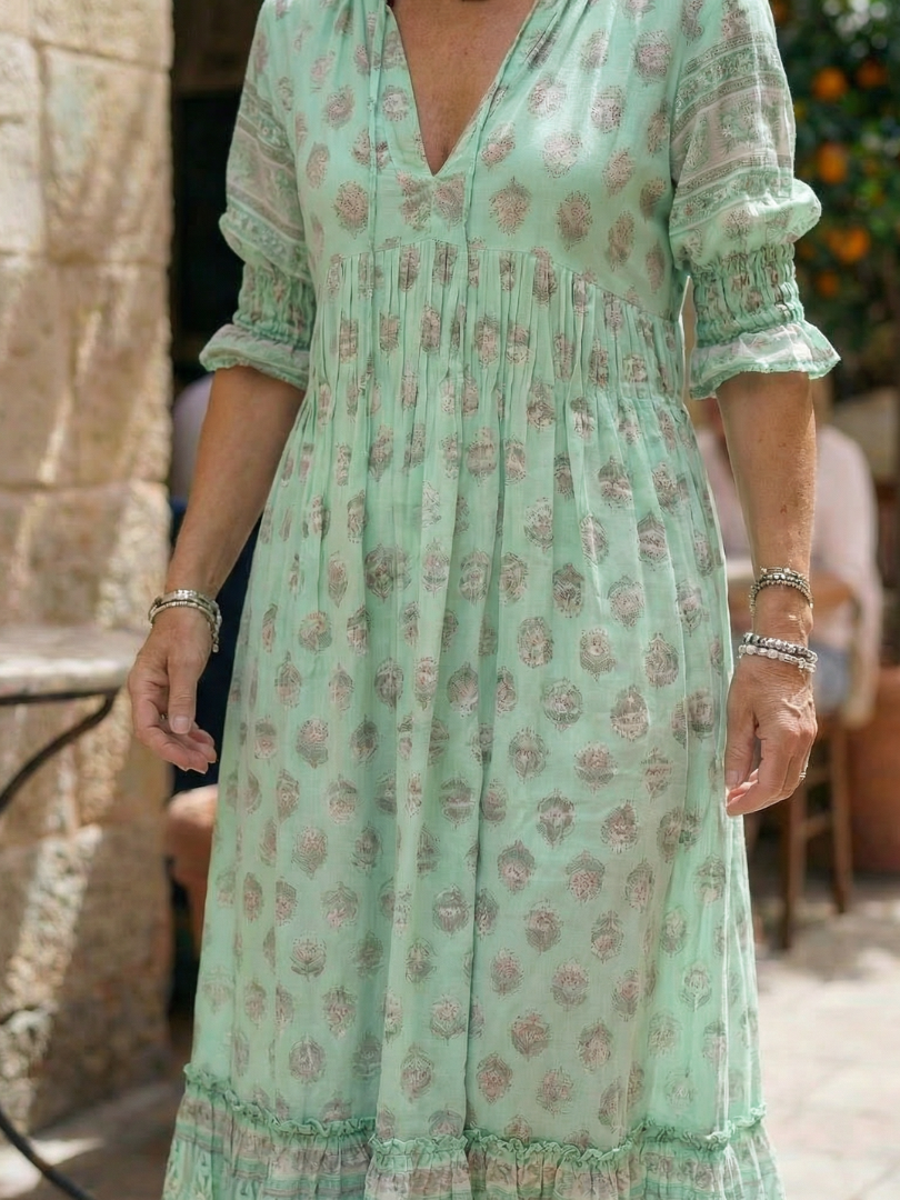 Mint green patterned midi dress with V-neck, puff sleeves and tiered skirt