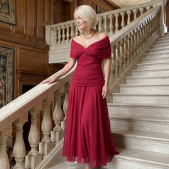 Off-shoulder maxi dress in deep red with sweetheart neckline and flowing chiffon skirt