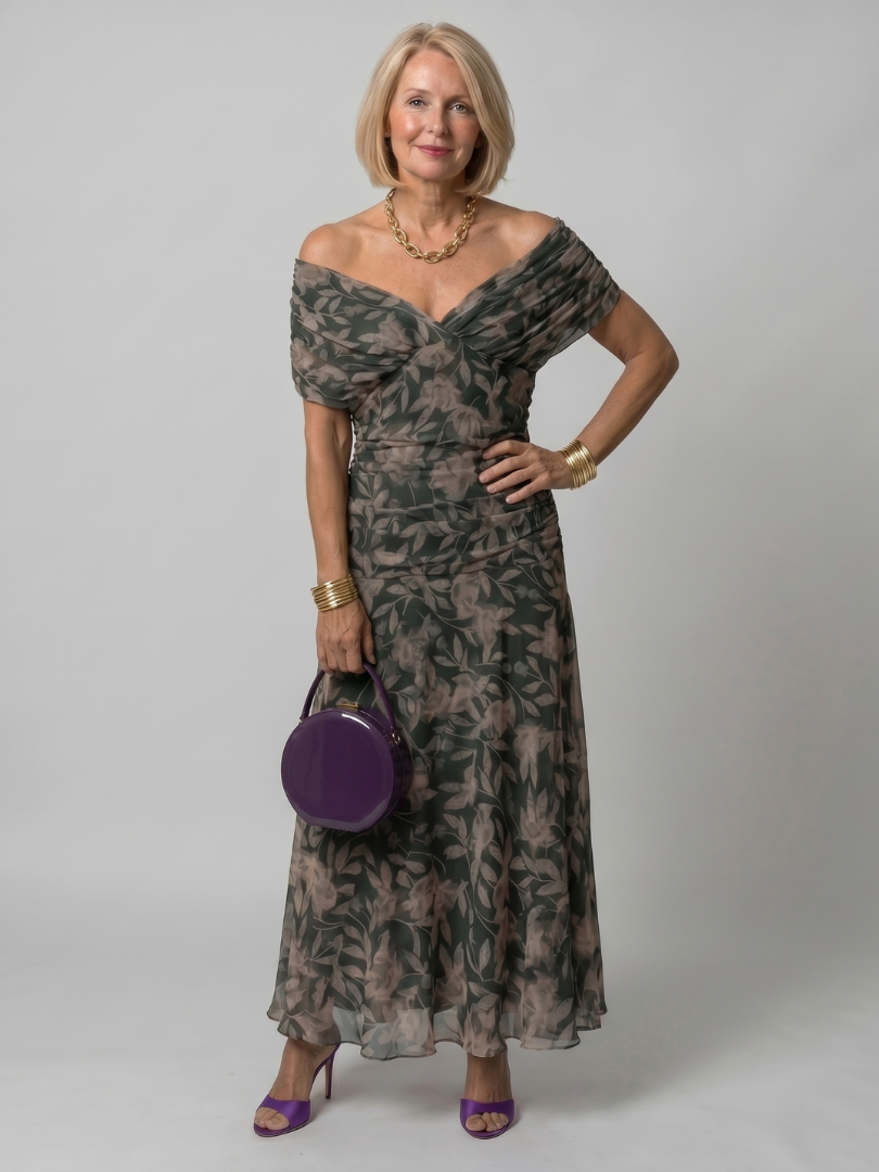 Off-shoulder maxi dress with dark green leaf print and tiered, flowing chiffon skirt