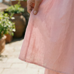 Pink layered midi dress with tiered ruffle hem and lightweight fabric
