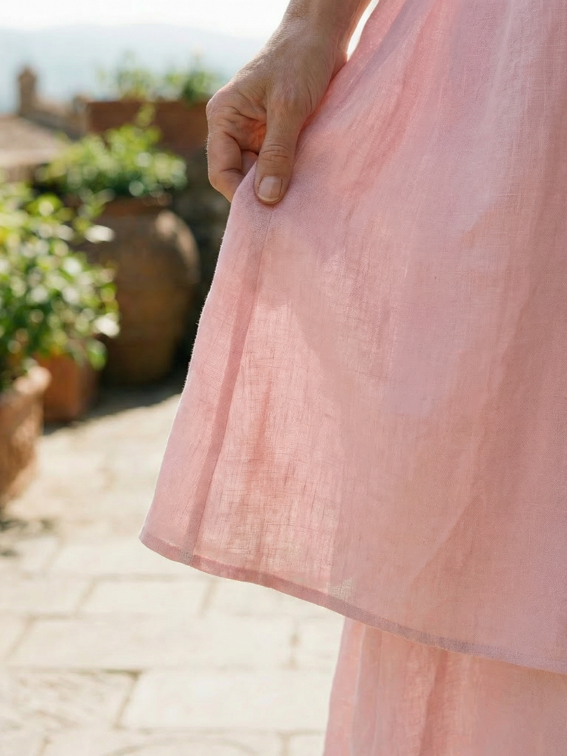 Pink layered midi dress with tiered ruffle hem and lightweight fabric