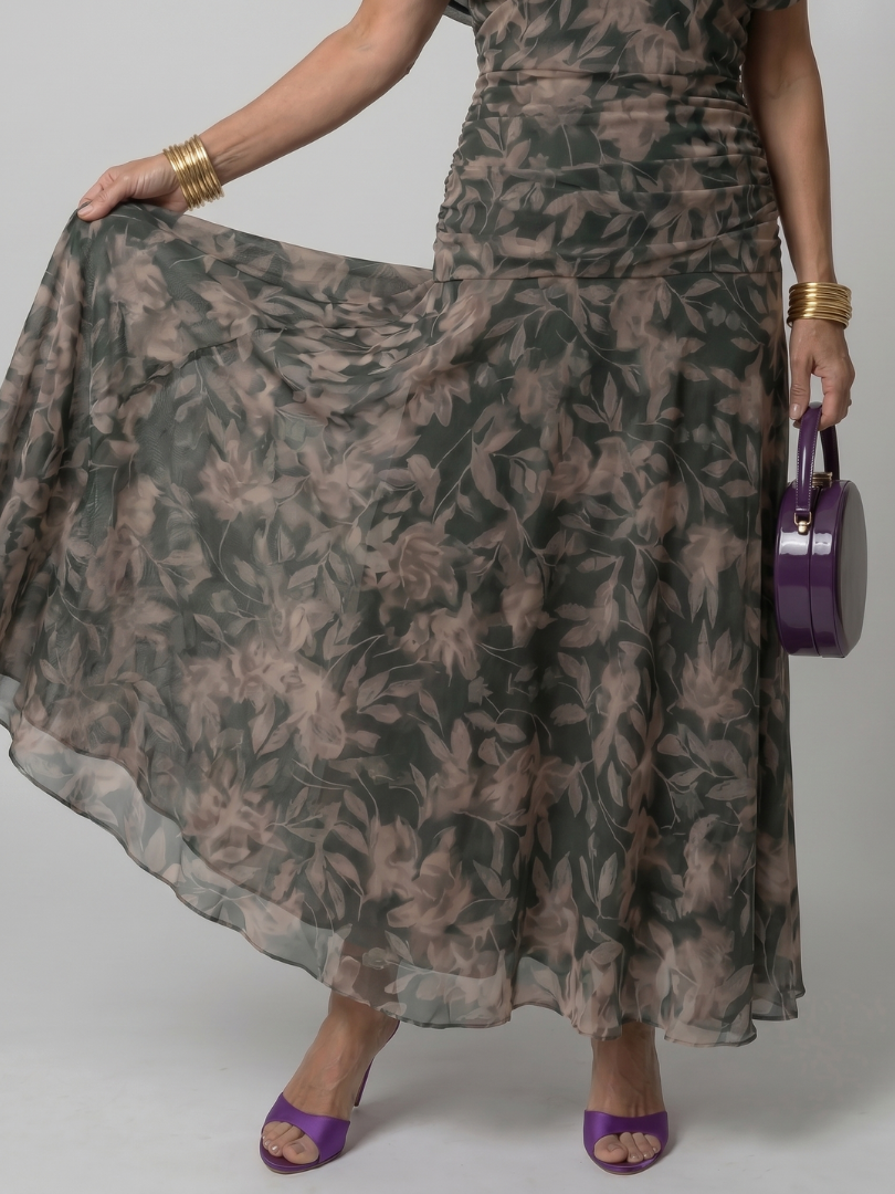 Off-shoulder maxi dress with dark green leaf print, close-up of gathered, sheer skirt