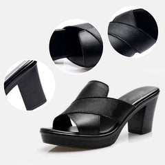 Black heeled platform sandals with wide straps and textured leather-like finish