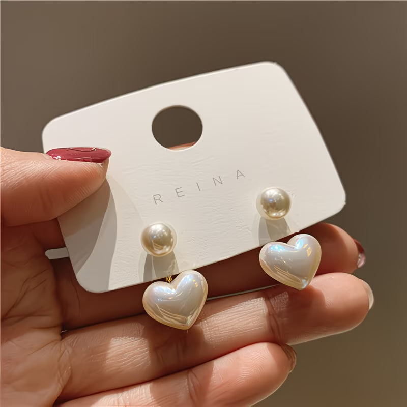 Double pearl heart earrings: white heart dangles with pearl studs on gold posts