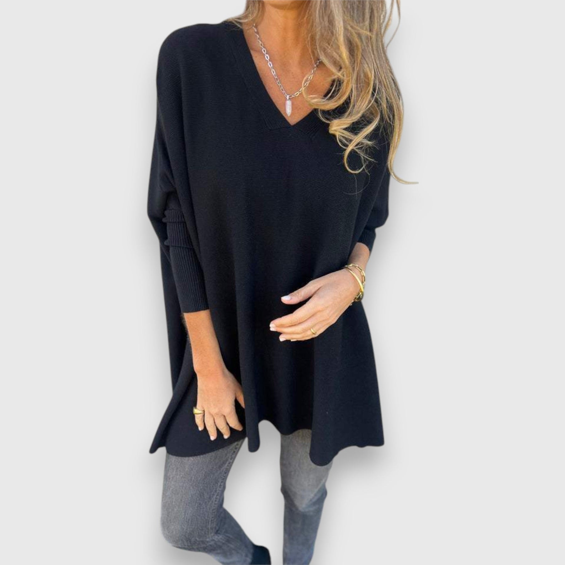 Black oversized V-neck sweater with loose knit and long sleeves.