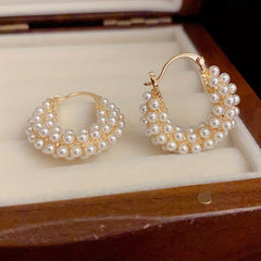 Layered pearl hoop earrings on display, gold-tone hoops with layered white pearls