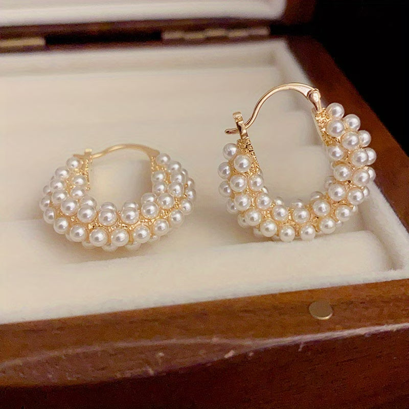 Layered pearl hoop earrings on display, gold-tone hoops with layered white pearls