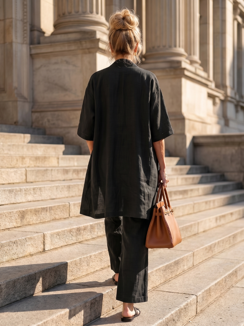 Black relaxed three-piece set seen from back with duster and wide-leg pants