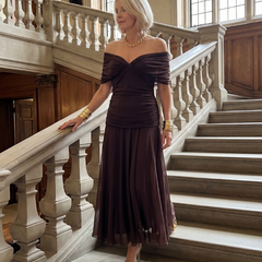 Off-shoulder flow maxi dress in dark brown with ruched bodice and flowing pleated skirt