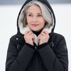 Black sherpa-lined parka close-up with hood, zip front, and insulated collar lining
