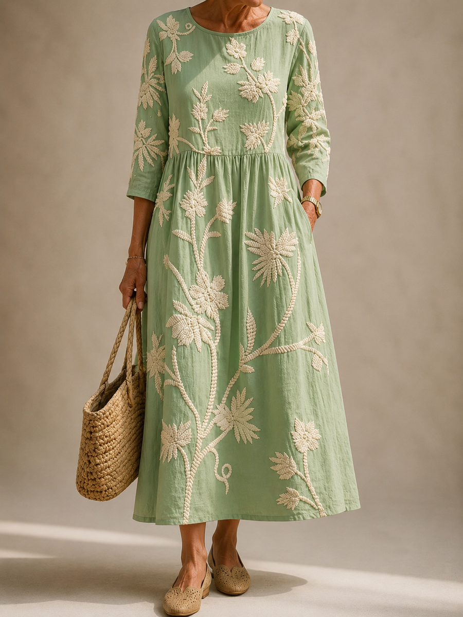Green midi dress with long sleeves and embroidered floral vine pattern