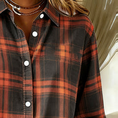 Plaid shirt chest close-up with notched collar and white buttons, orange and black