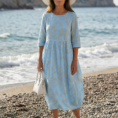 Sky blue garden-print midi dress with gold leaf pattern, three-quarter sleeves, gathered waist