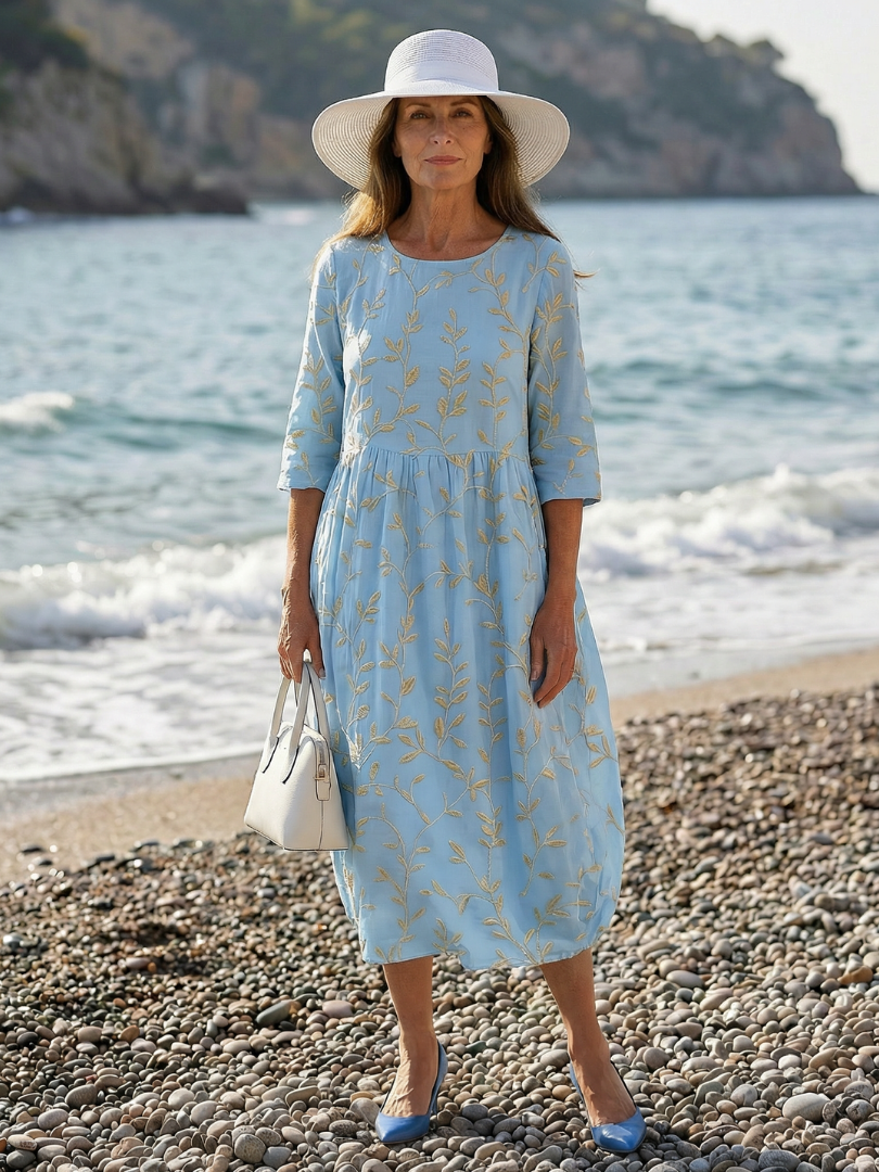 Sky blue garden-print midi dress with gold leaf pattern, three-quarter sleeves, gathered waist