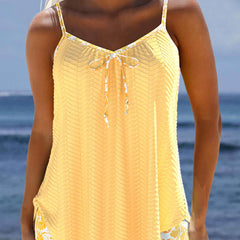 Light yellow tankini set with bow-tie front, patterned hem and adjustable straps.