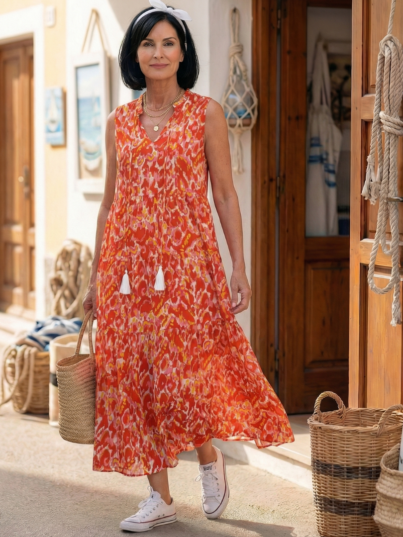 Orange sleeveless midi dress with V-neck, tassel-tie accents and tiered skirt